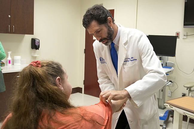 Dr. Don Rockey examines cirrhosis patient Angela Borei.