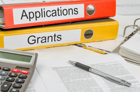 binders labeled application and grants 
