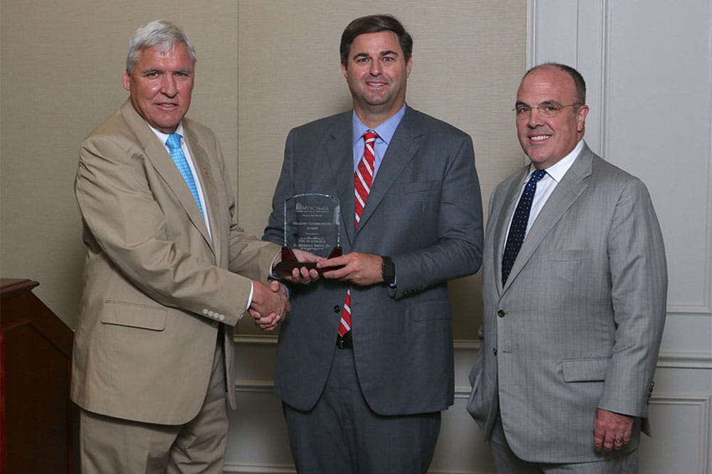 Dr. David Cole presents the Healthy Communities Award to Representative G. Murrell Smith, Jr., with Dr. Patrick Cawley.