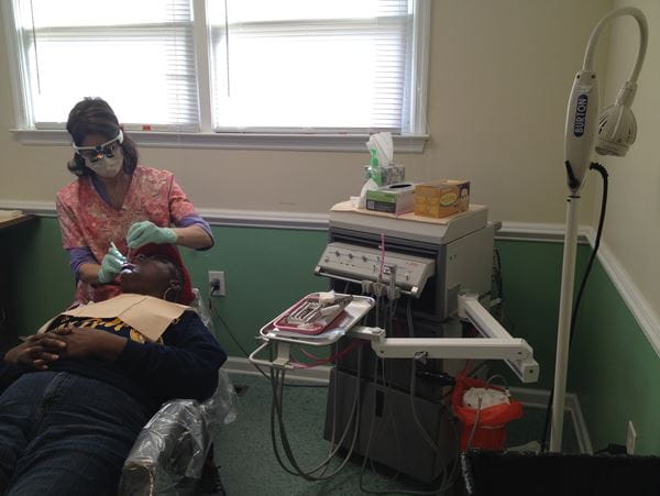 Dental hygienist providing dental services at Hollywood Smiles clinic (archival photo).