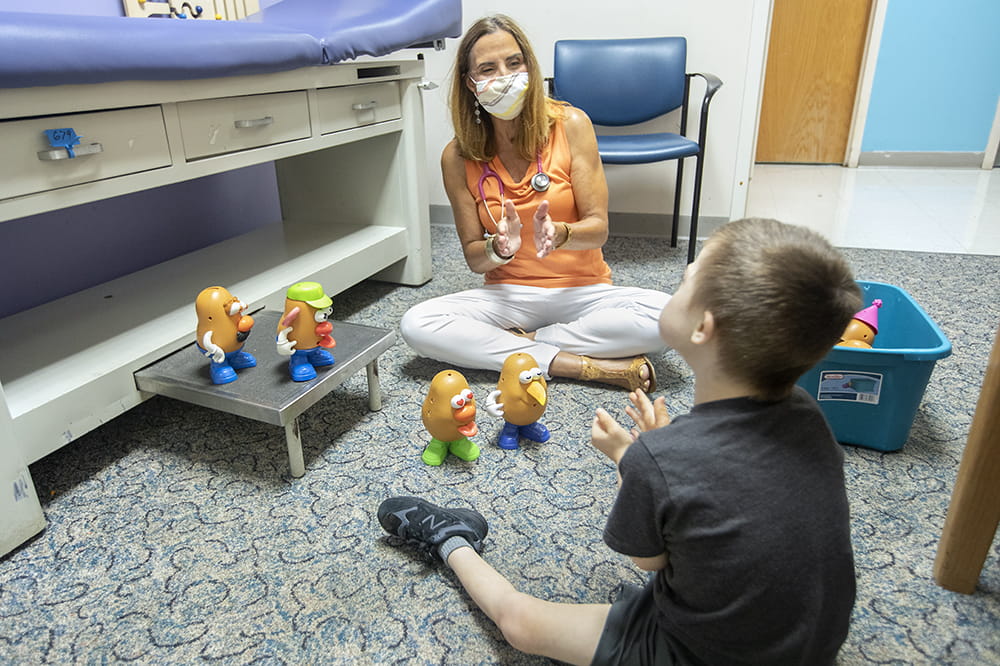 Angela C. LaRosa, M.D. plays with Freddie Taylor, a young patient with ADHD, at a recent doctor's visit. 