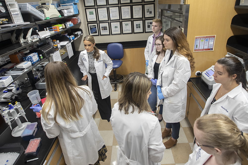 overhead shot of researchers students and interns gathered in the lab