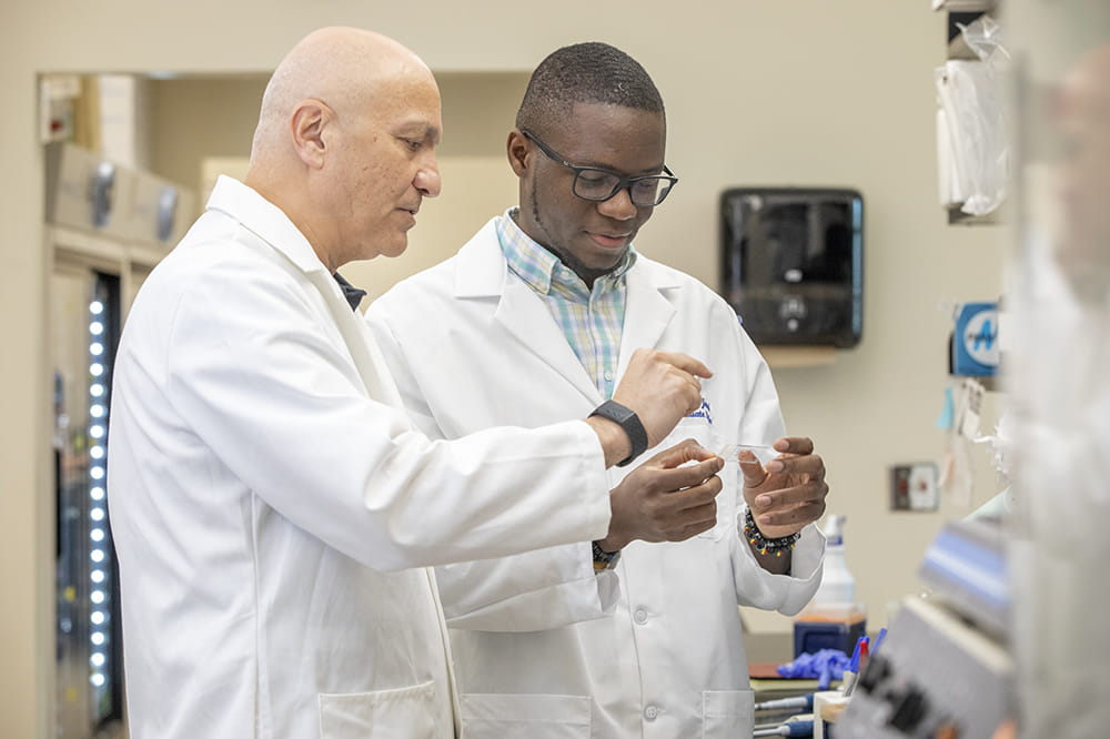 Dr. Besim Ogretmen teaching graduate student Alhaji Janneh in the laboratory.