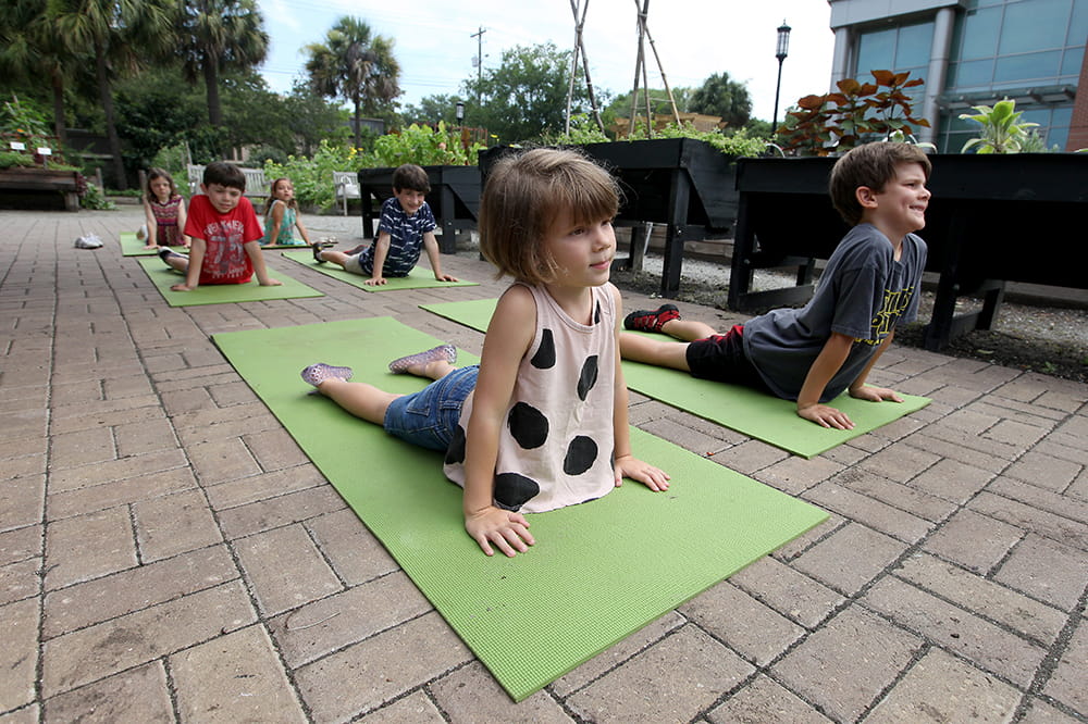 Children doing yoga in the MUSC Urban Farm