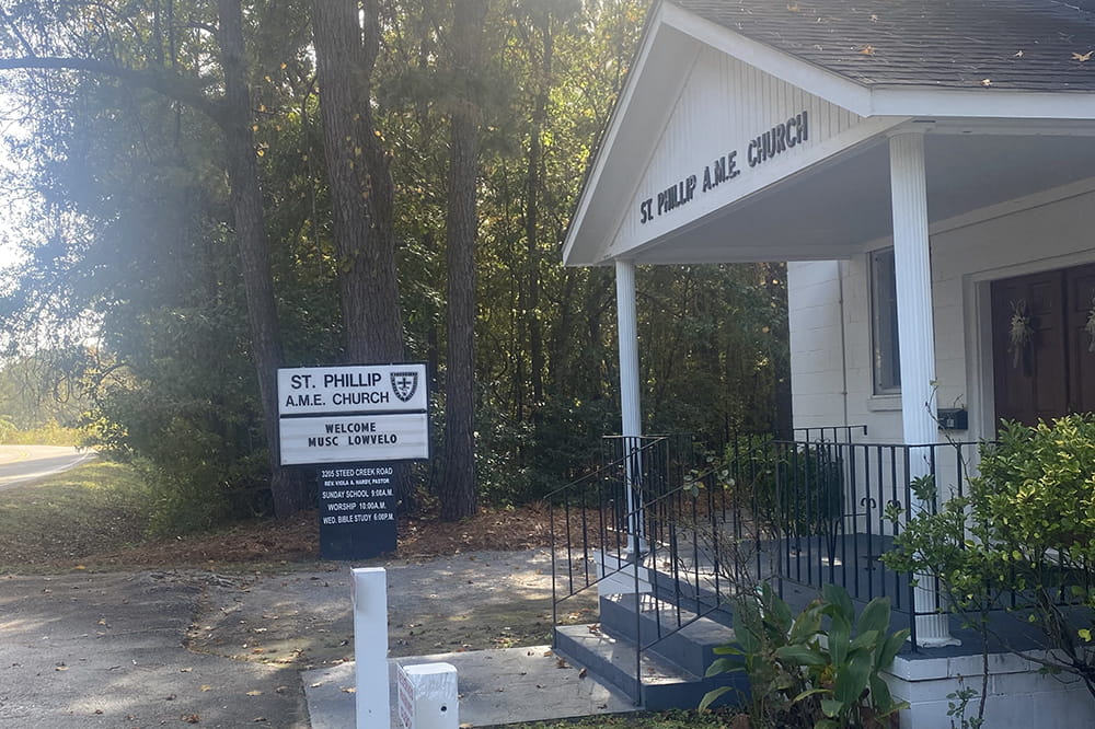 photo of a sign in front of rural church that says Welcome MUSC lowvelo