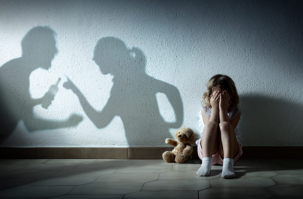 Little Girl Crying With Shadow Of Parents Arguing. Image by RomoloTavani. Licensed from istockphoto.com.