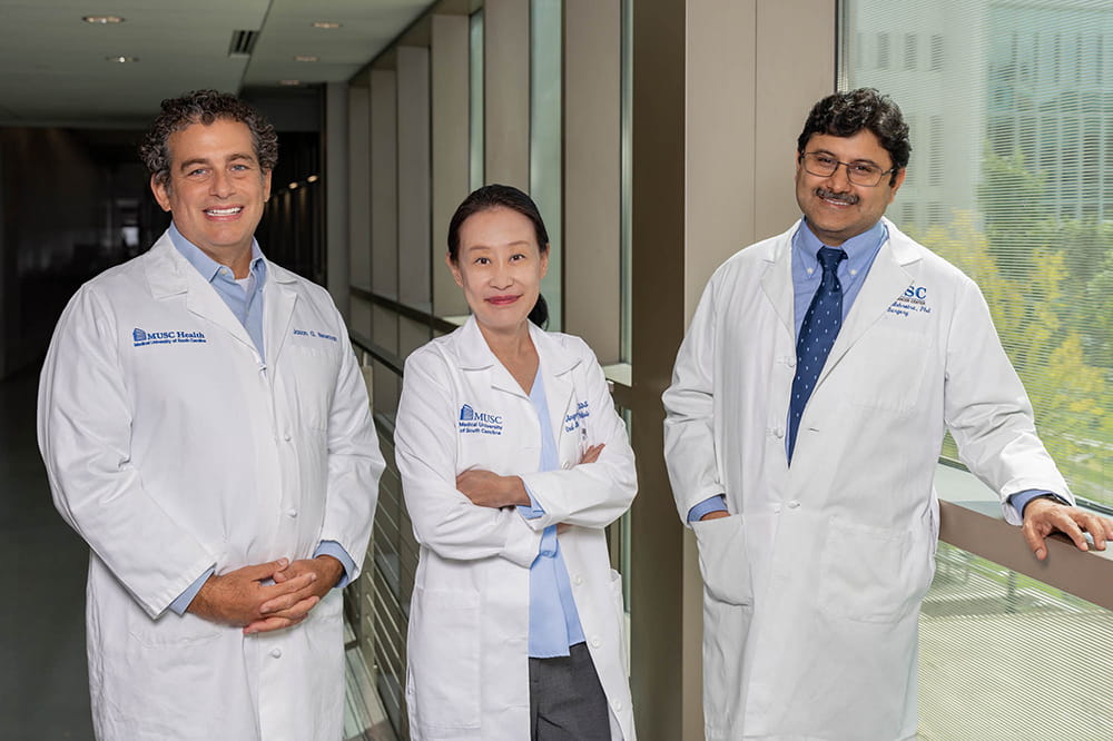 a trio of clinicians and researchers working together on an oral cancer vaccine