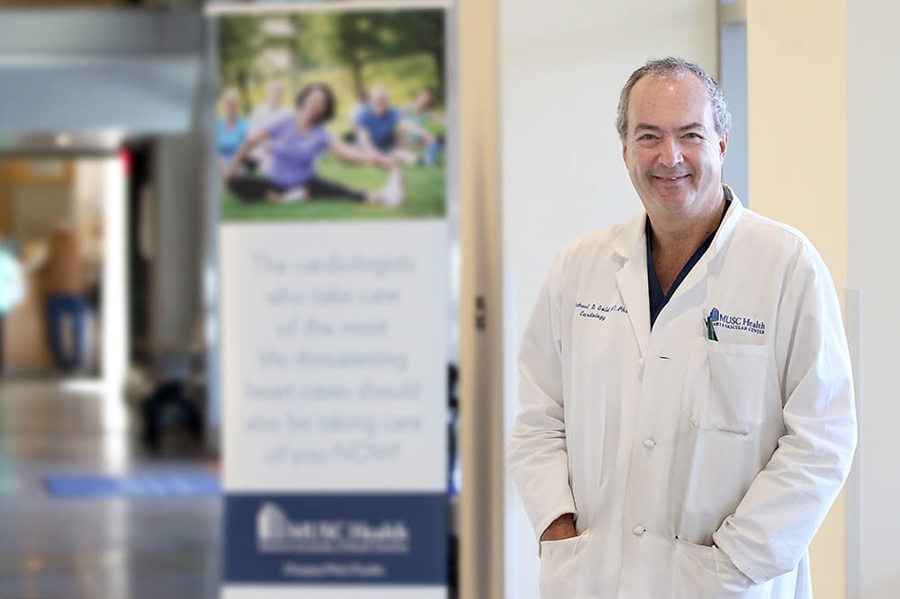 Dr. Michael Gold standing next to MUSC Health banner
