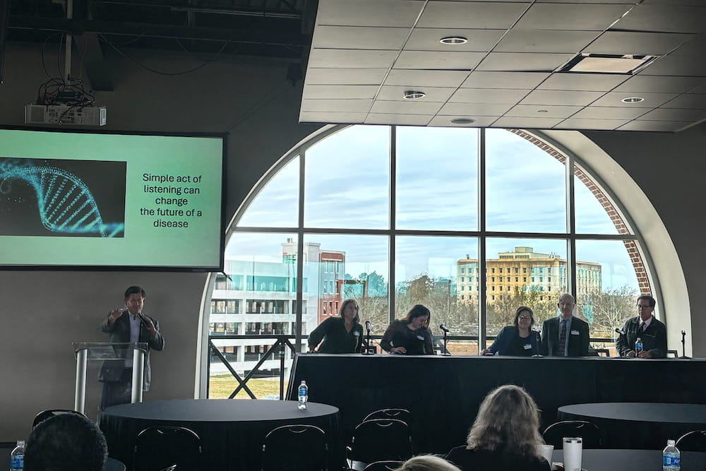 Rare Disease Advisory Council chair Dr. Patrick Flume (at podium) and the research panelists at the 2024 South Carolina Rare DIsease Symposium in Columbia. From left to right: Olivia Thompson, Maysen Mesaros, Dr. Neena Champaigne, Dr. Daniel Judge and Dr. Chip Norris.