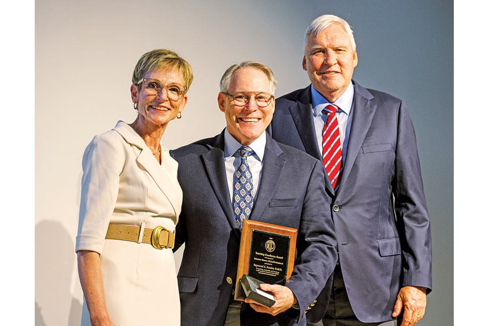 Dr. Raymond Kessler (Educator-Mentor-Clinical/Professional) accepts his award from Drs. Saladin and Cole on Aug. 13.  