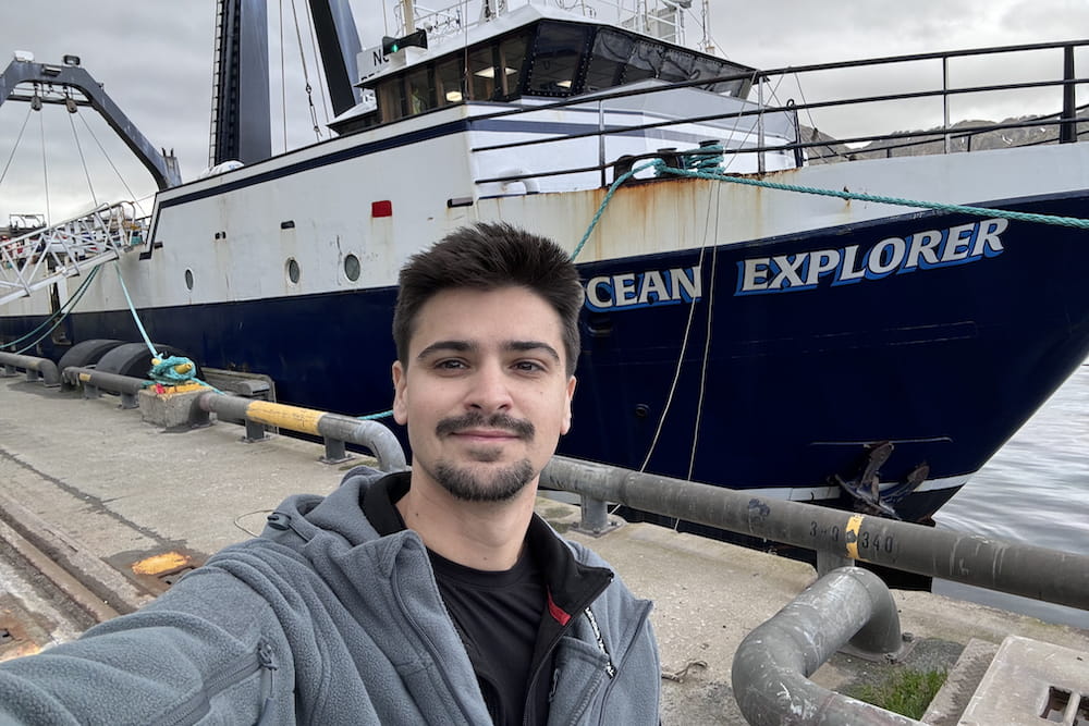 Menny Benjamin of the Mark Hamann Lab in front of the boat he took on a NOAA experedition, where he collected deep-sea sponges for pancreatic cancer research.