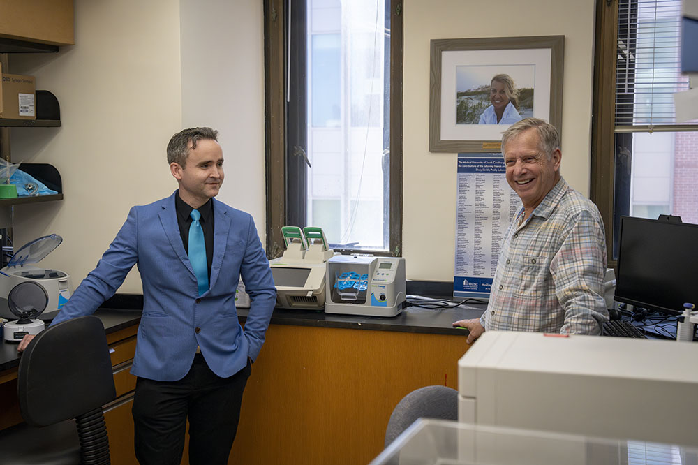 Researcher Joe Delaney and donor Matt Prisby chat in Delaney's lab