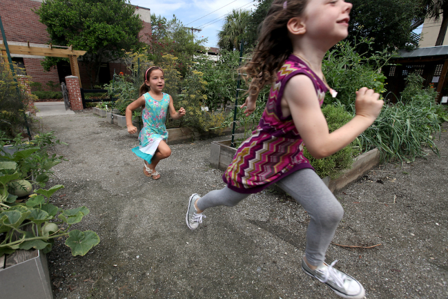 Children running through MUSC's Urban Farm