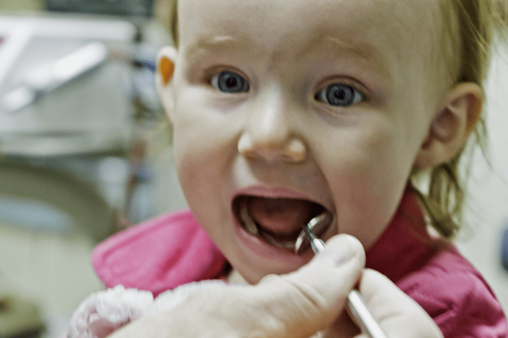 A little girl has her first visit to the dentist. Copyrighted photo by Dave Buchwald. CC by SA 3.0 license