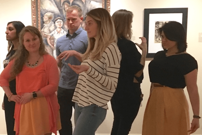 Health sciences students assume poses of subjects depicted in artwork at the Gibbes Museum.