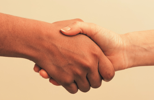 Two women hands in a handshake, original image by esolla from Getty Images Signature. Source: Canva Pro