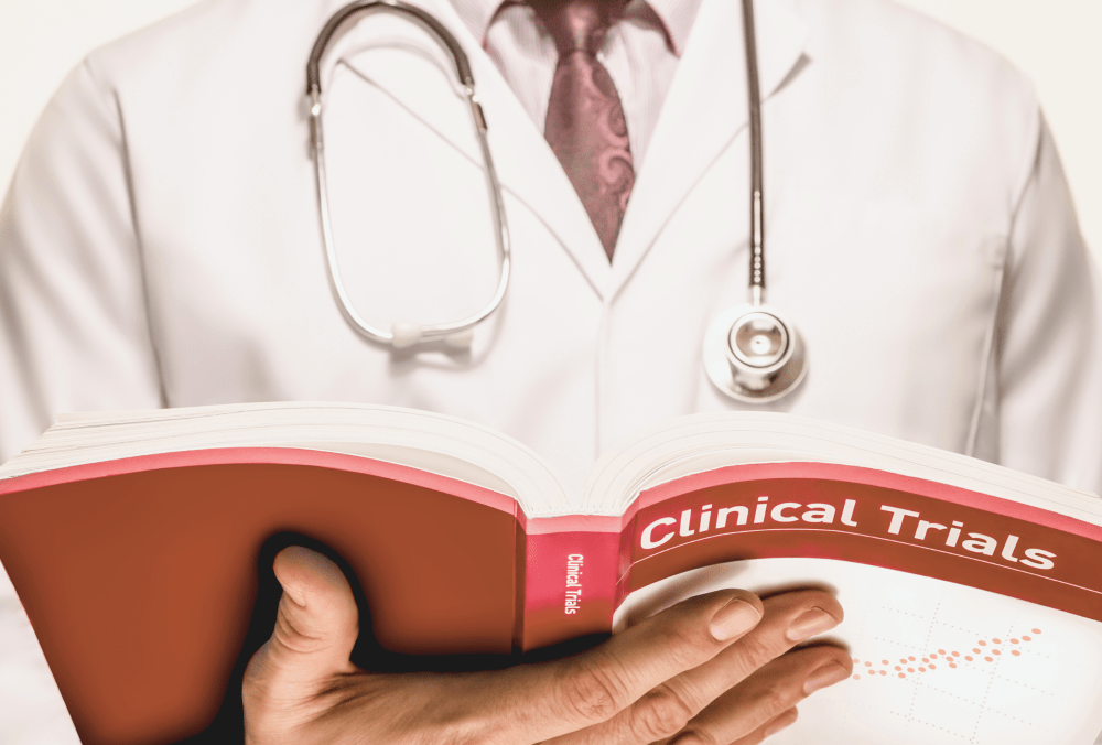 A physician holding a clinical trials text book by Theo_Theron from Getty Images. Source: Canva Pro